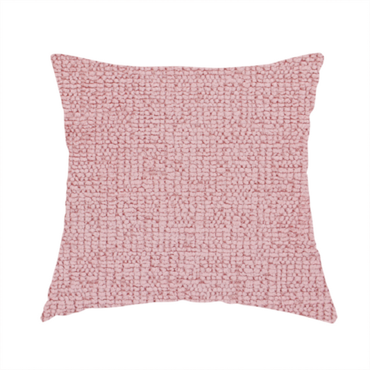 The fabric used to create this handmade cushion is a textured fabric swatch in a soft, dusty pink or rose colour. The material features a dense, uniform nubby weave with a matte finish, creating a gentle and welcoming appearance.