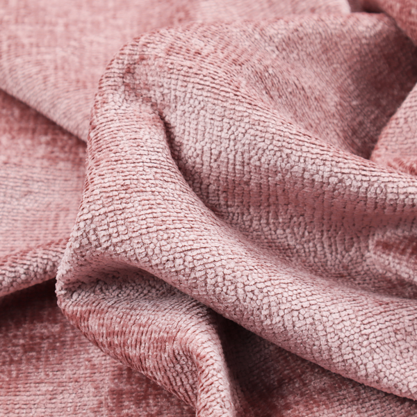A textured fabric swatch in a soft, dusty pink or rose colour. The material features a dense, uniform nubby weave with a matte finish, creating a gentle and welcoming appearance.