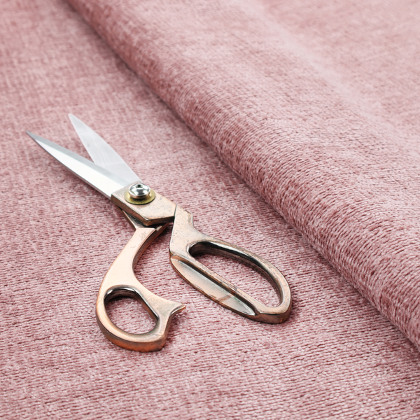 A textured fabric swatch in a soft, dusty pink or rose colour. The material features a dense, uniform nubby weave with a matte finish, creating a gentle and welcoming appearance.