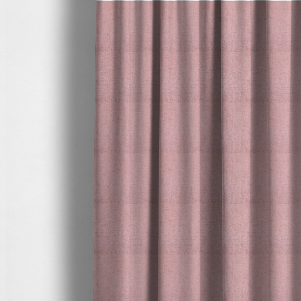 The fabric used to create these made-to-measure curtains is a textured fabric swatch in a soft, dusty pink or rose colour. The material features a dense, uniform nubby weave with a matte finish, creating a gentle and welcoming appearance.