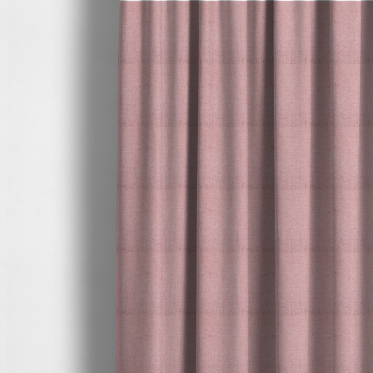 The fabric used to create these made-to-measure curtains is a textured fabric swatch in a soft, dusty pink or rose colour. The material features a dense, uniform nubby weave with a matte finish, creating a gentle and welcoming appearance.