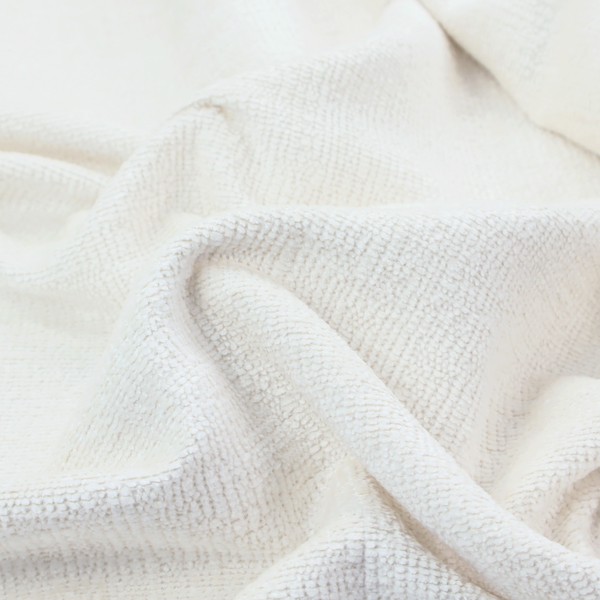 A textured fabric swatch in a crisp, clean white or off-white colour. The material features a dense, uniform nubby weave with a soft, matte finish, creating a bright and minimalist appearance.