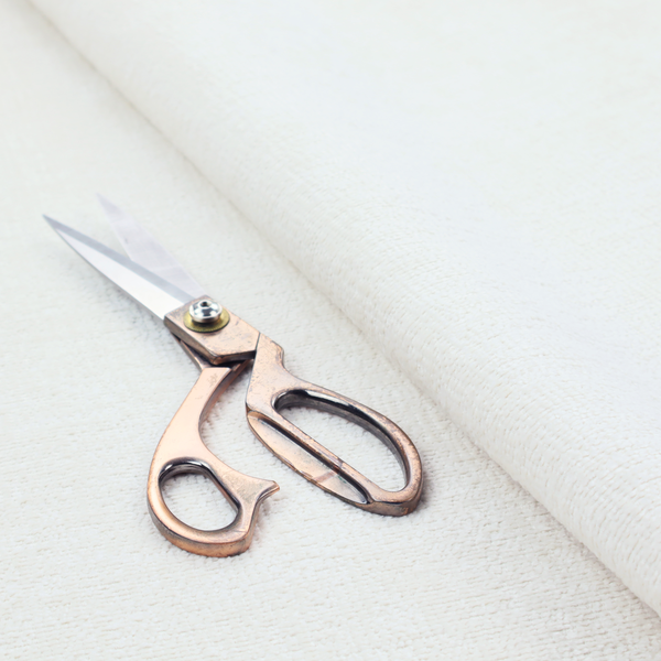 A textured fabric swatch in a crisp, clean white or off-white colour. The material features a dense, uniform nubby weave with a soft, matte finish, creating a bright and minimalist appearance.