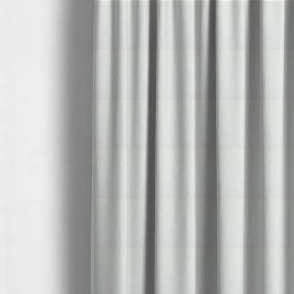 The fabric used to create these made-to-measure curtains is a textured fabric swatch in a crisp, clean white or off-white colour. The material features a dense, uniform nubby weave with a soft, matte finish, creating a bright and minimalist appearance.