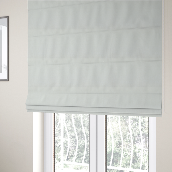 The fabric used to create these Roman blinds is a textured fabric swatch in a crisp, clean white or off-white colour. The material features a dense, uniform nubby weave with a soft, matte finish, creating a bright and minimalist appearance.