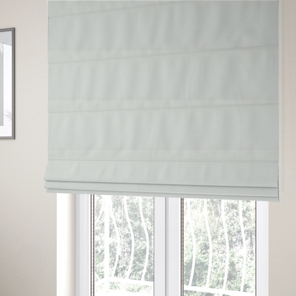 The fabric used to create these Roman blinds is a textured fabric swatch in a crisp, clean white or off-white colour. The material features a dense, uniform nubby weave with a soft, matte finish, creating a bright and minimalist appearance.