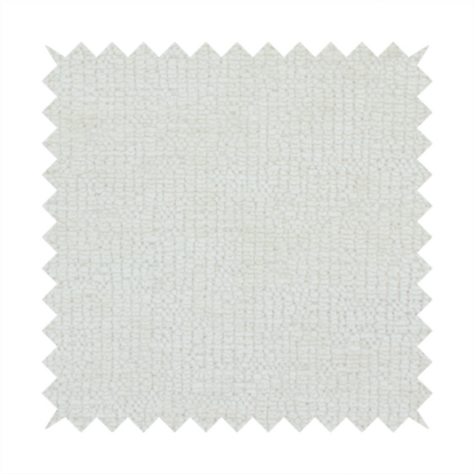 A textured fabric swatch in a soft cream, ivory, or natural off-white colour. The material features a dense, uniform nubby weave with subtle warm undertones, creating a cosy and clean appearance.