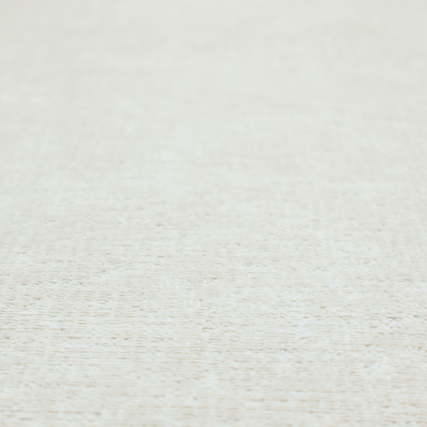 A textured fabric swatch in a soft cream, ivory, or natural off-white colour. The material features a dense, uniform nubby weave with subtle warm undertones, creating a cosy and clean appearance.