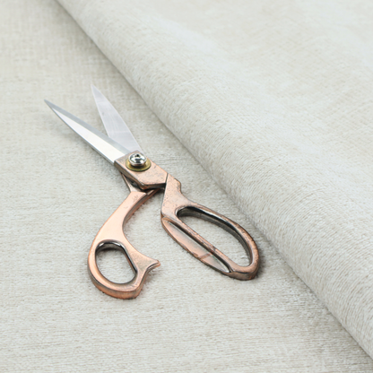 A textured fabric swatch in a soft cream, ivory, or natural off-white colour. The material features a dense, uniform nubby weave with subtle warm undertones, creating a cosy and clean appearance.