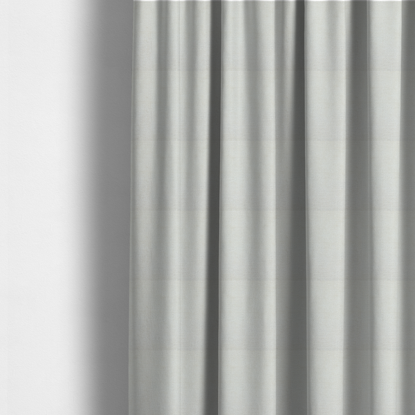 The fabric used to create these made-to-measure curtains is a textured fabric swatch in a soft cream, ivory, or natural off-white colour. The material features a dense, uniform nubby weave with subtle warm undertones, creating a cosy and clean appearance.