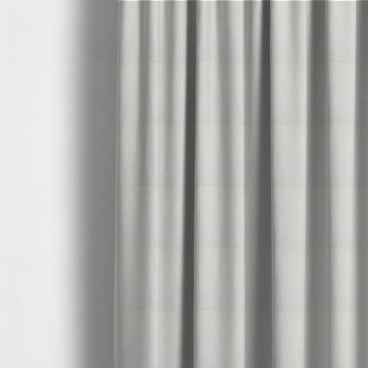 The fabric used to create these made-to-measure curtains is a textured fabric swatch in a soft cream, ivory, or natural off-white colour. The material features a dense, uniform nubby weave with subtle warm undertones, creating a cosy and clean appearance.
