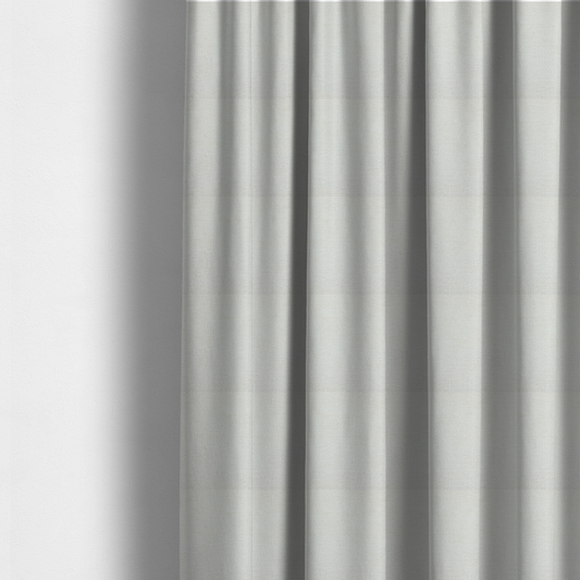 The fabric used to create these made-to-measure curtains is a textured fabric swatch in a soft cream, ivory, or natural off-white colour. The material features a dense, uniform nubby weave with subtle warm undertones, creating a cosy and clean appearance.