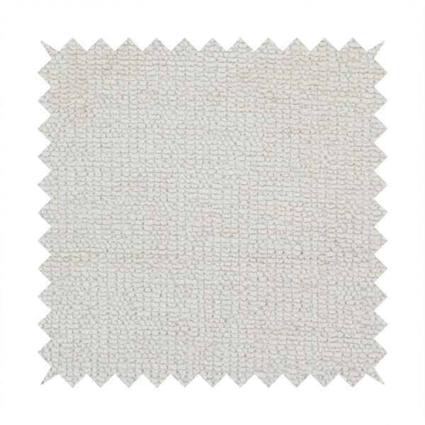A textured fabric swatch in a very pale, light beige or ecru colour. The material features a dense, uniform nubby weave with subtle neutral undertones, creating a soft, warm-toned minimalist appearance.