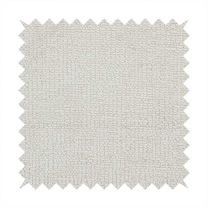 A textured fabric swatch in a very pale, light beige or ecru colour. The material features a dense, uniform nubby weave with subtle neutral undertones, creating a soft, warm-toned minimalist appearance.