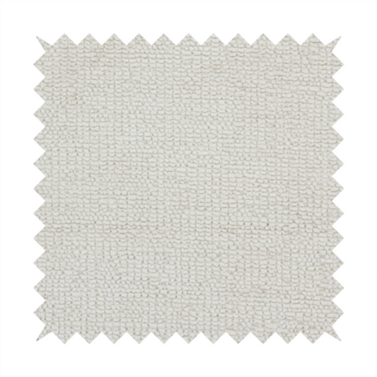 A textured fabric swatch in a very pale, light beige or ecru colour. The material features a dense, uniform nubby weave with subtle neutral undertones, creating a soft, warm-toned minimalist appearance.
