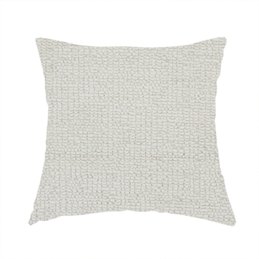 the fabric used to create this handmade cushion is a textured fabric swatch in a very pale, light beige or ecru colour. The material features a dense, uniform nubby weave with subtle neutral undertones, creating a soft, warm-toned minimalist appearance.