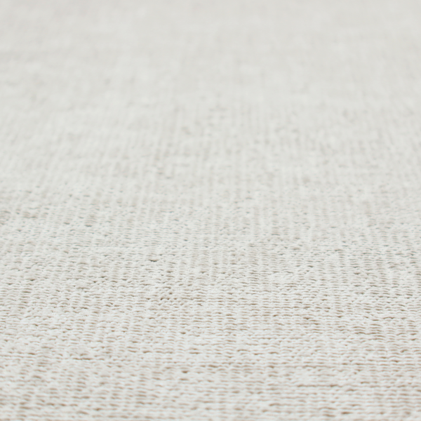 A textured fabric swatch in a very pale, light beige or ecru colour. The material features a dense, uniform nubby weave with subtle neutral undertones, creating a soft, warm-toned minimalist appearance.