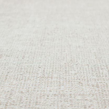 A textured fabric swatch in a very pale, light beige or ecru colour. The material features a dense, uniform nubby weave with subtle neutral undertones, creating a soft, warm-toned minimalist appearance.