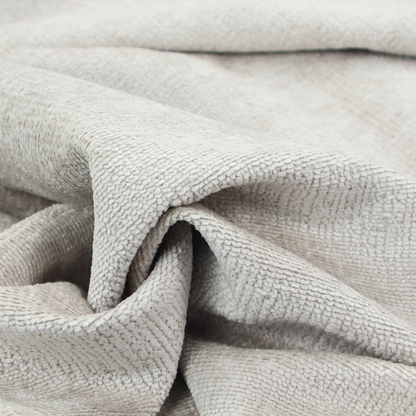 A textured fabric swatch in a very pale, light beige or ecru colour. The material features a dense, uniform nubby weave with subtle neutral undertones, creating a soft, warm-toned minimalist appearance.