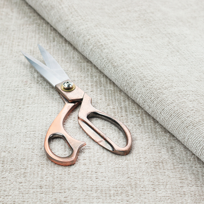 A textured fabric swatch in a very pale, light beige or ecru colour. The material features a dense, uniform nubby weave with subtle neutral undertones, creating a soft, warm-toned minimalist appearance.