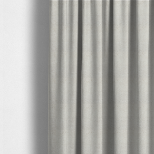 The fabric used to create these made-to-measure curtains is a textured fabric swatch in a very pale, light beige or ecru colour. The material features a dense, uniform nubby weave with subtle neutral undertones, creating a soft, warm-toned minimalist appearance.