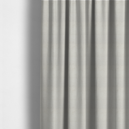 The fabric used to create these made-to-measure curtains is a textured fabric swatch in a very pale, light beige or ecru colour. The material features a dense, uniform nubby weave with subtle neutral undertones, creating a soft, warm-toned minimalist appearance.