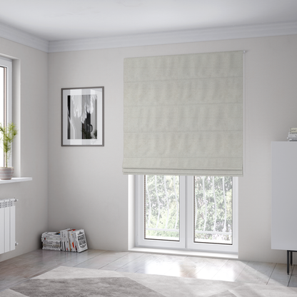 The fabric used to create these Roman blinds is a textured fabric swatch in a very pale, light beige or ecru colour. The material features a dense, uniform nubby weave with subtle neutral undertones, creating a soft, warm-toned minimalist appearance.