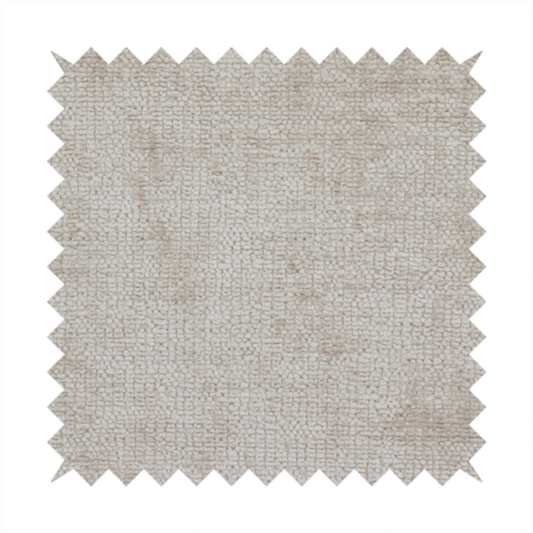 A textured fabric swatch in a light, neutral taupe or sandy beige colour. The material features a dense, uniform nubby weave with subtle horizontal striations and warm grey undertones, creating a soft, multi-tonal appearance.