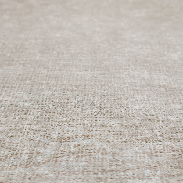 A textured fabric swatch in a light, neutral taupe or sandy beige colour. The material features a dense, uniform nubby weave with subtle horizontal striations and warm grey undertones, creating a soft, multi-tonal appearance.