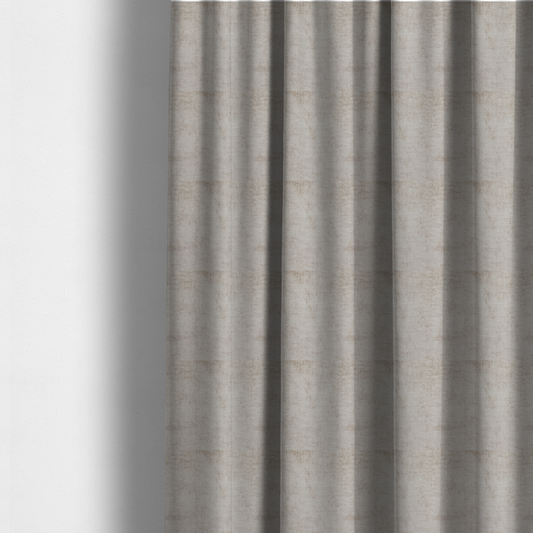 The fabric used to create these made-to-measure curtains is a textured fabric swatch in a light, neutral taupe or sandy beige colour. The material features a dense, uniform nubby weave with subtle horizontal striations and warm grey undertones, creating a soft, multi-tonal appearance.