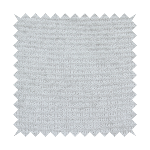 A textured fabric swatch in a very pale, light grey or silver colour. The material features a dense, uniform nubby weave with subtle neutral undertones, creating a soft, clean, and modern appearance.