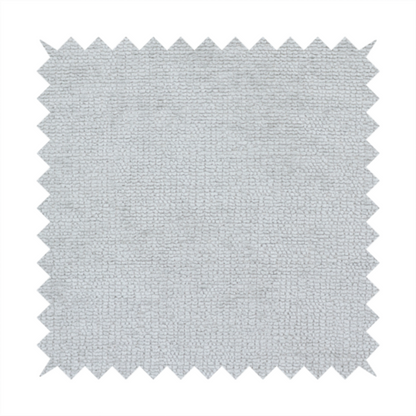 A textured fabric swatch in a very pale, light grey or silver colour. The material features a dense, uniform nubby weave with subtle neutral undertones, creating a soft, clean, and modern appearance.