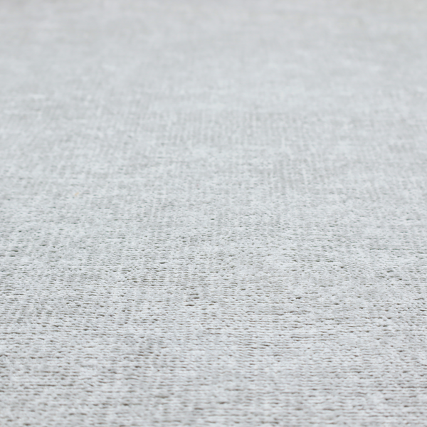 A textured fabric swatch in a very pale, light grey or silver colour. The material features a dense, uniform nubby weave with subtle neutral undertones, creating a soft, clean, and modern appearance.