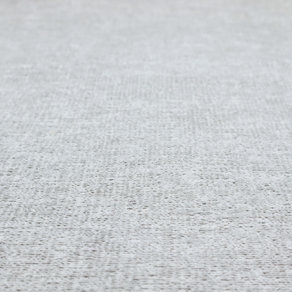A textured fabric swatch in a very pale, light grey or silver colour. The material features a dense, uniform nubby weave with subtle neutral undertones, creating a soft, clean, and modern appearance.
