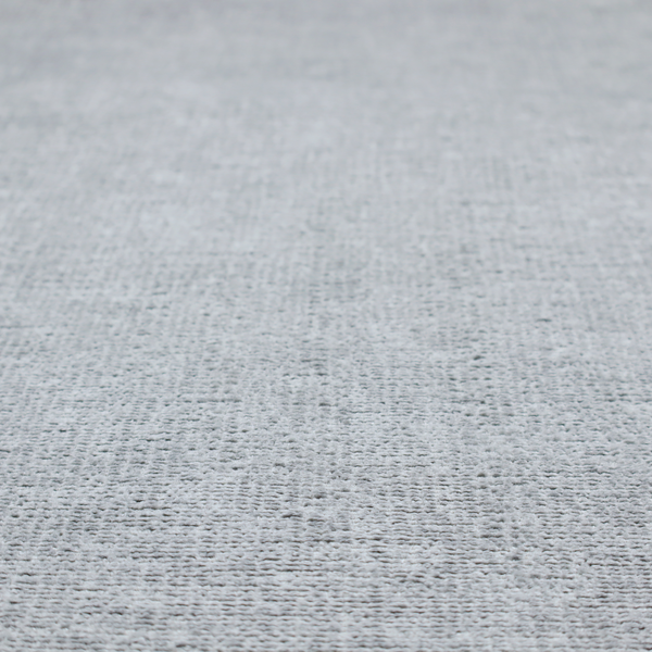A textured fabric swatch in a cool, light-to-medium grey or stone colour. The material features a dense, uniform nubby weave with subtle horizontal shadowing, creating a soft, contemporary matte finish.