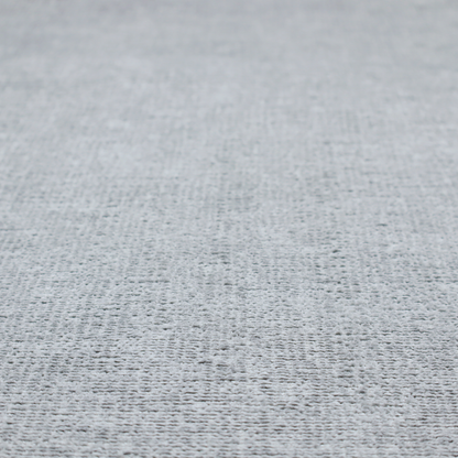A textured fabric swatch in a cool, light-to-medium grey or stone colour. The material features a dense, uniform nubby weave with subtle horizontal shadowing, creating a soft, contemporary matte finish.