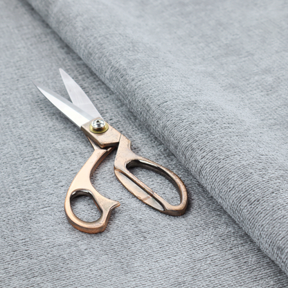 A textured fabric swatch in a cool, light-to-medium grey or stone colour. The material features a dense, uniform nubby weave with subtle horizontal shadowing, creating a soft, contemporary matte finish.