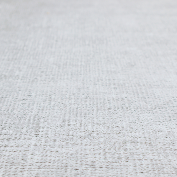 A textured fabric swatch in a very light, icy grey or pale ash colour. The material features a dense, uniform nubby weave with bright neutral tones, creating a clean, crisp, and contemporary appearance.