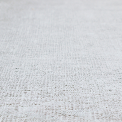 A textured fabric swatch in a very light, icy grey or pale ash colour. The material features a dense, uniform nubby weave with bright neutral tones, creating a clean, crisp, and contemporary appearance.