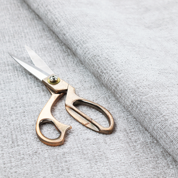 A textured fabric swatch in a very light, icy grey or pale ash colour. The material features a dense, uniform nubby weave with bright neutral tones, creating a clean, crisp, and contemporary appearance.