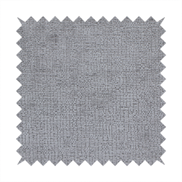 A textured fabric swatch in a medium grey or slate colour. The material features a dense, uniform nubby weave with subtle dark and light shading variations, creating a soft, multi-tonal contemporary look.