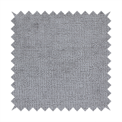 A textured fabric swatch in a medium grey or slate colour. The material features a dense, uniform nubby weave with subtle dark and light shading variations, creating a soft, multi-tonal contemporary look.