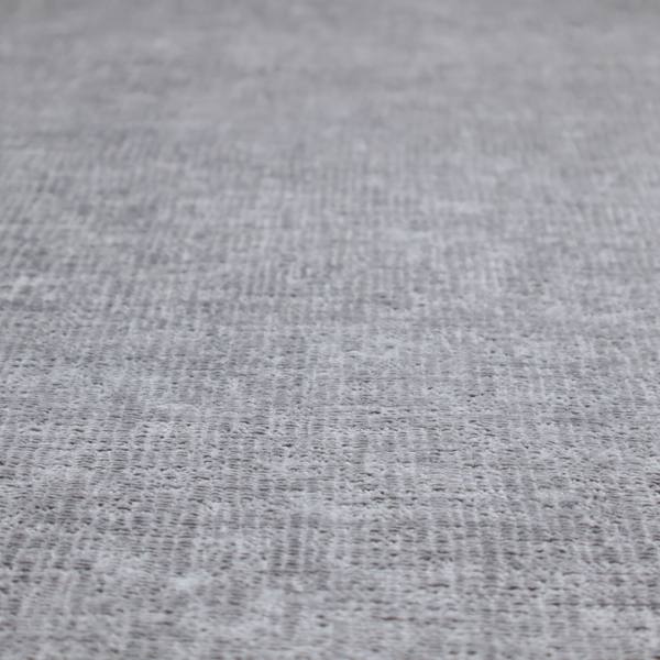 A textured fabric swatch in a medium grey or slate colour. The material features a dense, uniform nubby weave with subtle dark and light shading variations, creating a soft, multi-tonal contemporary look.