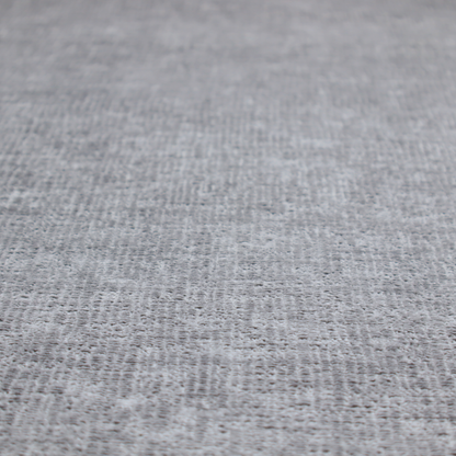 A textured fabric swatch in a medium grey or slate colour. The material features a dense, uniform nubby weave with subtle dark and light shading variations, creating a soft, multi-tonal contemporary look.