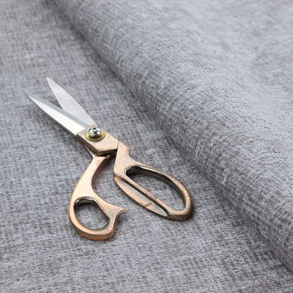 A textured fabric swatch in a medium grey or slate colour. The material features a dense, uniform nubby weave with subtle dark and light shading variations, creating a soft, multi-tonal contemporary look.
