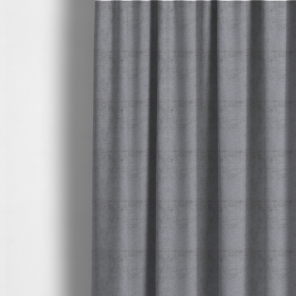 The fabric used to create these made-to-measure curtains is a textured fabric swatch in a medium grey or slate colour. The material features a dense, uniform nubby weave with subtle dark and light shading variations, creating a soft, multi-tonal contemporary look.