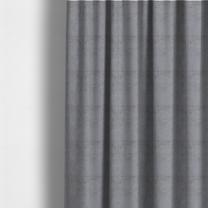 The fabric used to create these made-to-measure curtains is a textured fabric swatch in a medium grey or slate colour. The material features a dense, uniform nubby weave with subtle dark and light shading variations, creating a soft, multi-tonal contemporary look.