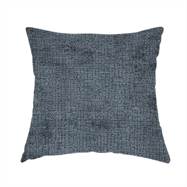 The fabric used to create this handmade cushion is a textured fabric swatch in a dark charcoal or graphite grey colour. The material features a dense, uniform nubby weave with deep, moody undertones and subtle dark shadowing, creating a rich, contemporary appearance.