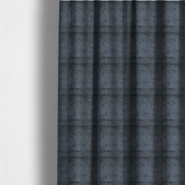 The fabric used to create these made-to-measure curtains is a textured fabric swatch in a dark charcoal or graphite grey colour. The material features a dense, uniform nubby weave with deep, moody undertones and subtle dark shadowing, creating a rich, contemporary appearance.