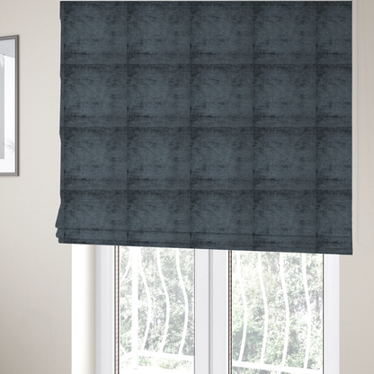 The fabric used to create these Roman blinds is a textured fabric swatch in a dark charcoal or graphite grey colour. The material features a dense, uniform nubby weave with deep, moody undertones and subtle dark shadowing, creating a rich, contemporary appearance.